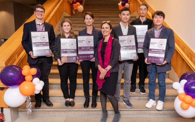 2023 Innovation Forum Cornelia Huellstrunk and the winners standing a staircase with their awards