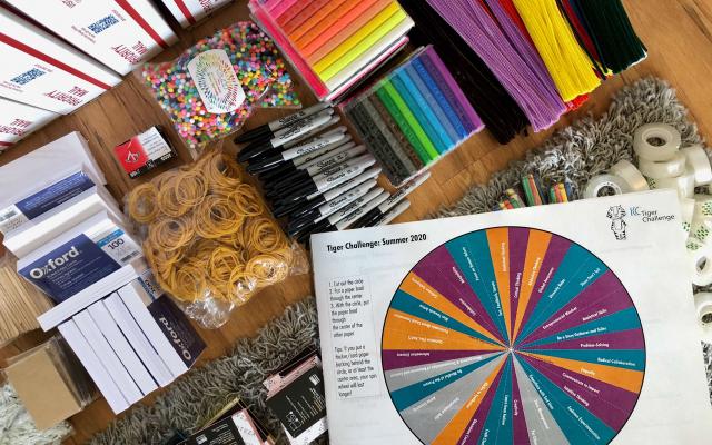 Display of various design materials: rubber bands, black sharpies, clay, post-its