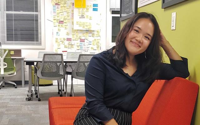 Jessica Leung sitting on an orange couch 