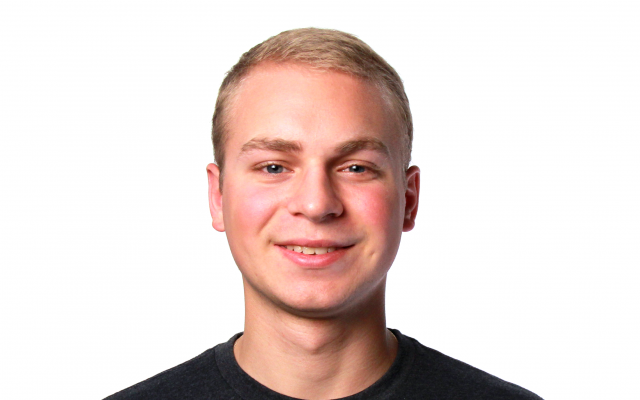 Man with blonde hair in black t-shirt