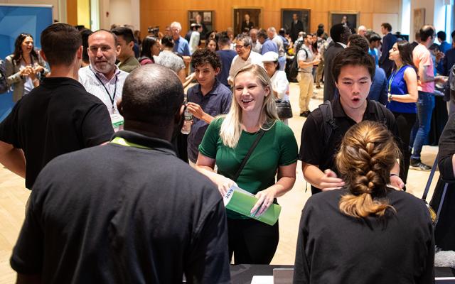 Students and guests network at Demo Day event