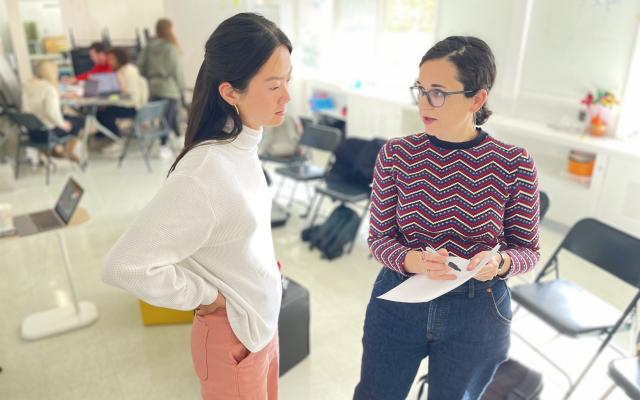 Alice Kogan and Janeen Zheng talking in Keller's bright creative classroom
