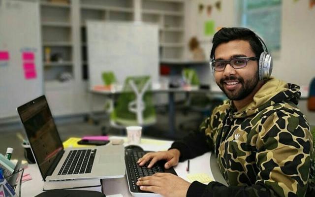 Smiling young man working in the Entrepreneurial Hub at Princeton