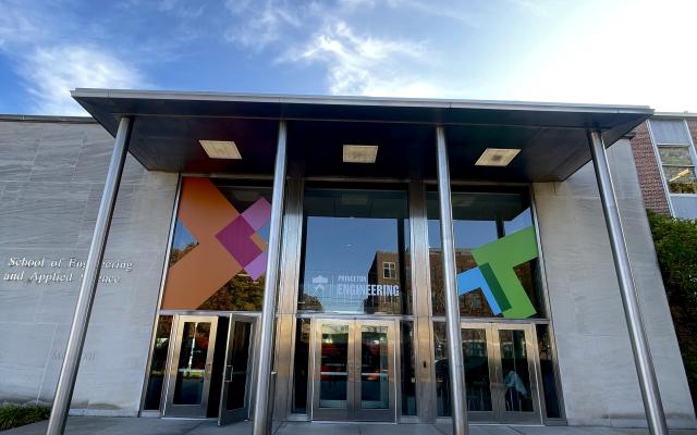 The E-Quad building main doors under a beautiful blue sky.