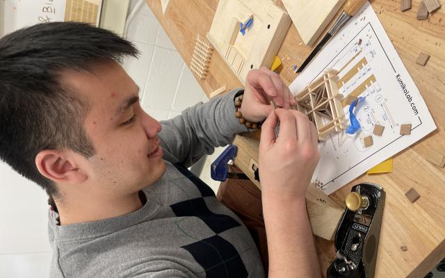 A man working on a Kumiko wood project