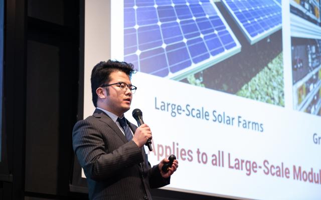 A person presenting in front of a PowerPoint slide at Innovation Forum