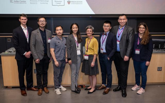 Innovation Forum winners standing together in front of a large presentation screen