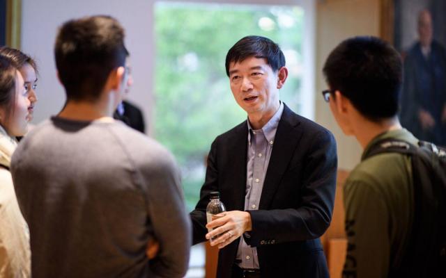 James Mi speaking to a group of students  