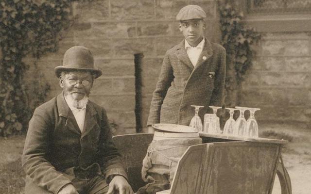 William Taylor at Princeton sitting at his cart, a young boy is standing beside him