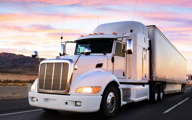 Eighteen wheel truck driving on the highway.