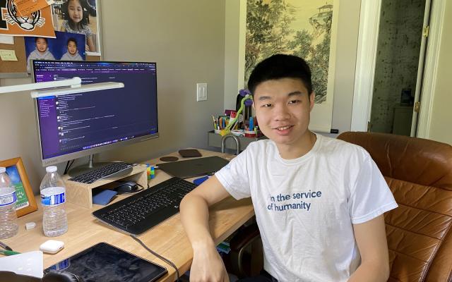 Smiling college student sitting at desk