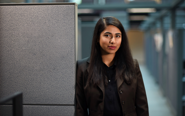 Soha Aslam leaning against a cubicle wall