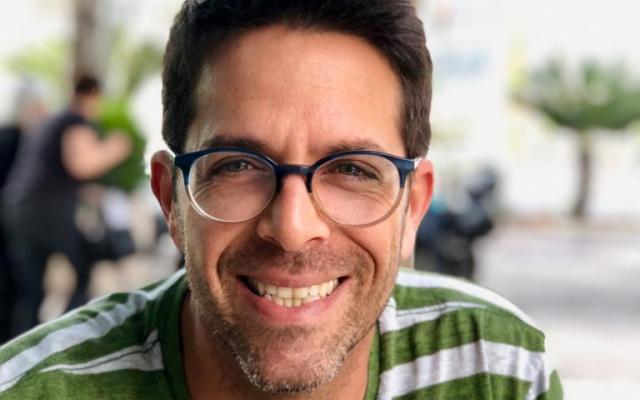 Man with glasses and green striped shirt 