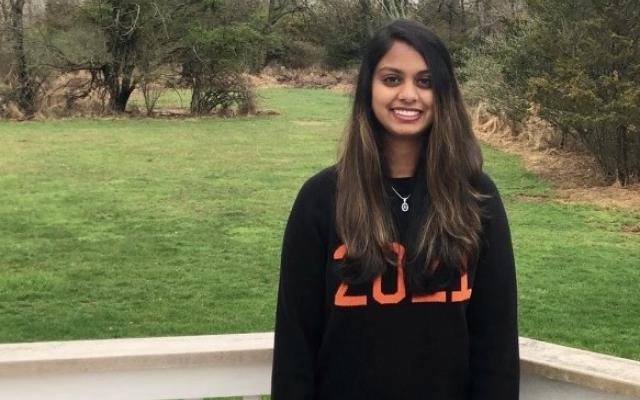 Chitra Parikh in a Princeton sweater on a porch