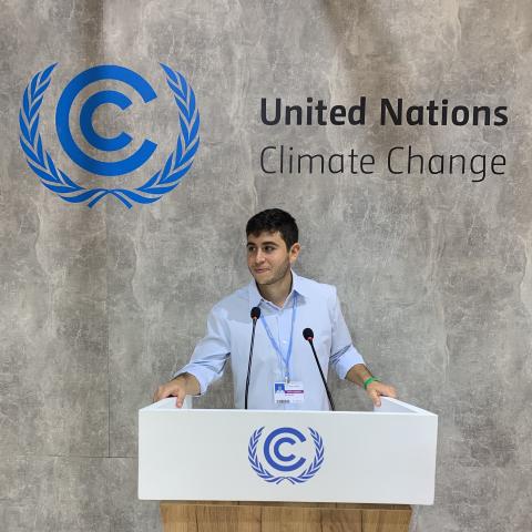 Student at United Nations Climate Change conference podium