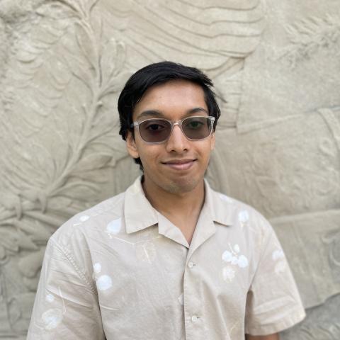 Student smiling in front of monument