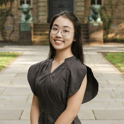 Student smiling in courtyard